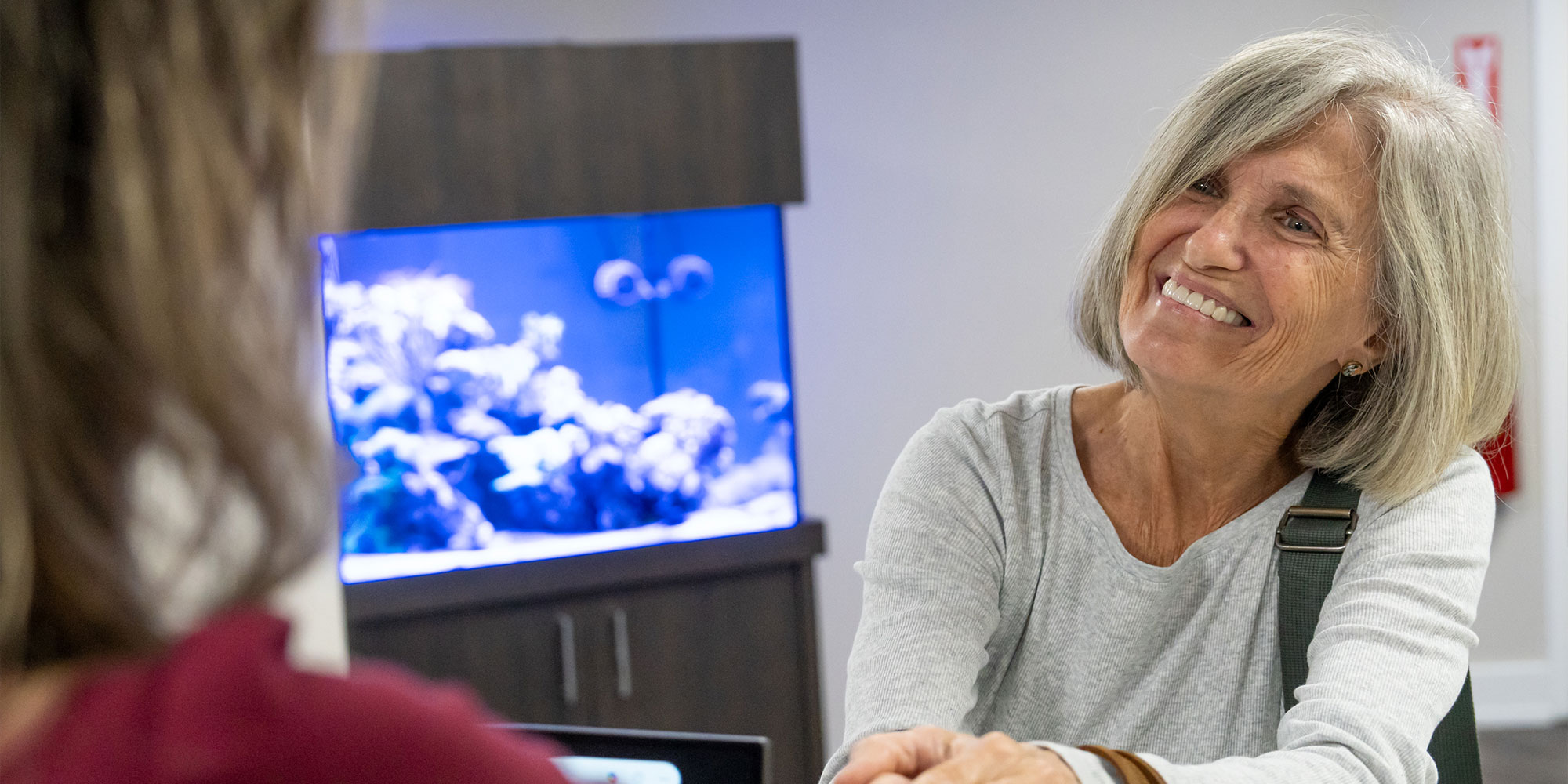 patient being helped at the front desk of the dental center