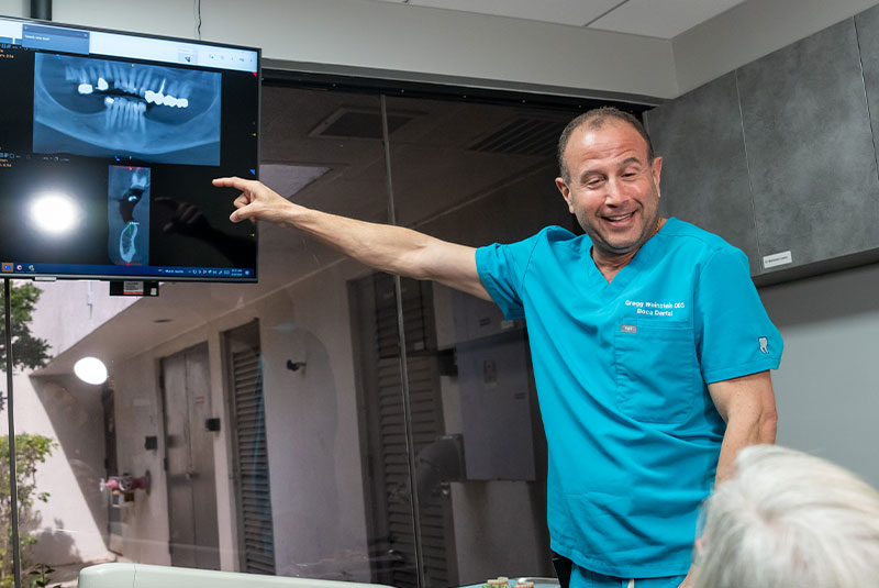 doctor helping patient go over dental procedure information