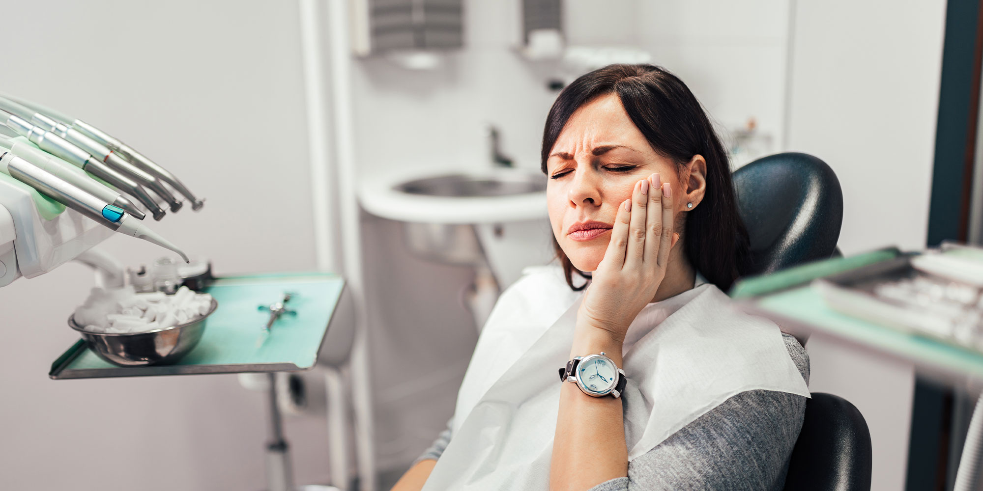 person with mouth pain inside of the dental center