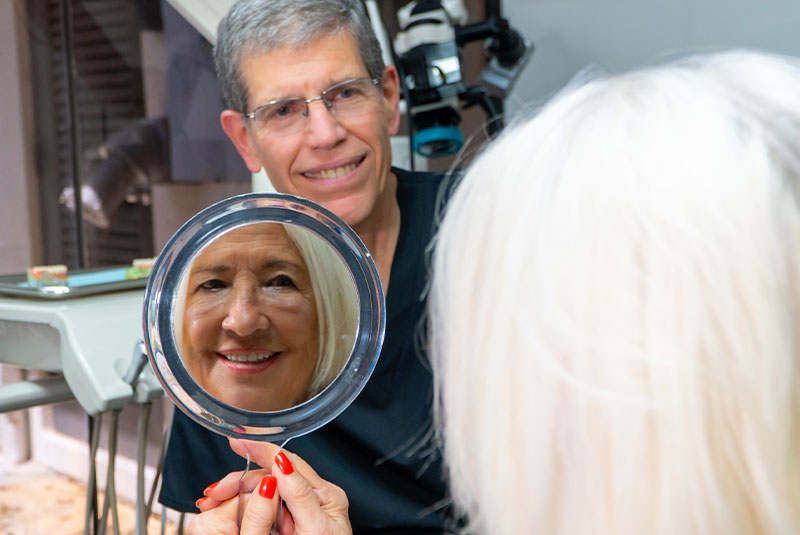 patient smiling brightly after their dental treatment within the dental center