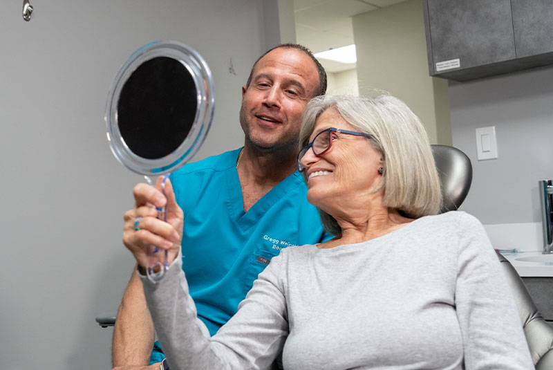 patient smiling with the doctor after patient's dental procedure