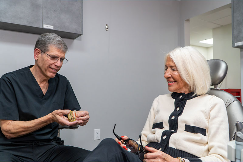 doctor and patient going over and looking at dental procedure information together