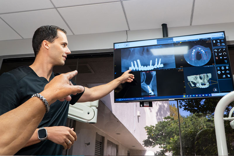 doctor and patient looking over dental procedure information with the help of the dental center technology